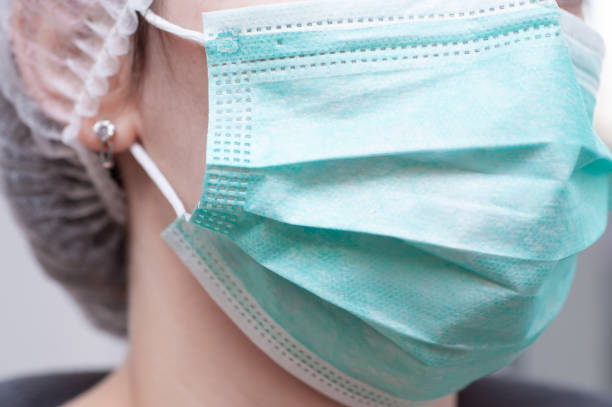doctor holding facemask as a preventive measure of coronavirus - медицина imagens e fotografias de stock