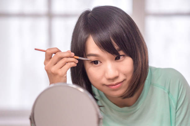 istock asian women make up her face in room 1212222642