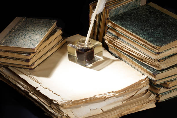 istock Old quill pen and old papers with inkwell 1212222980