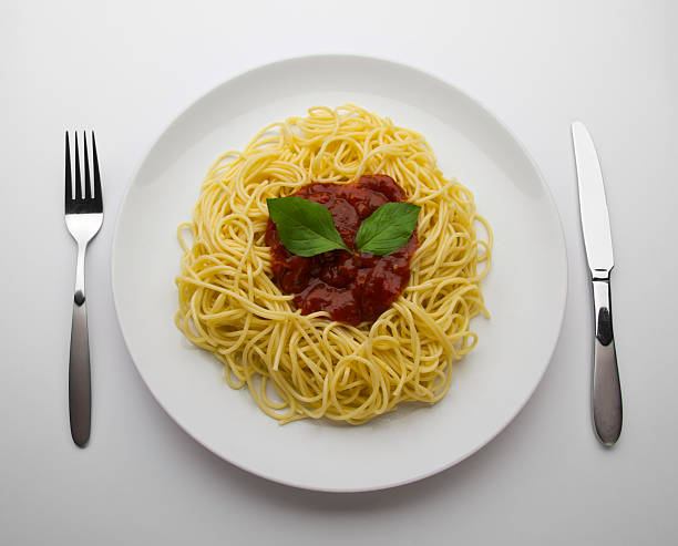 spaghetti with tomato sauce and basil stock photo