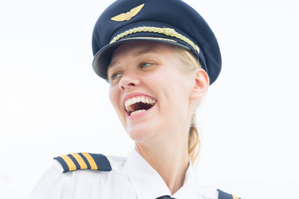 happy pilot woman walking at the airport smiling. - cabin crew pilot airport walking imagens e fotografias de stock