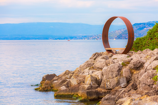 Panoramic view of Lake Geneva, Switzerland and viewpoint bench in round metal circle