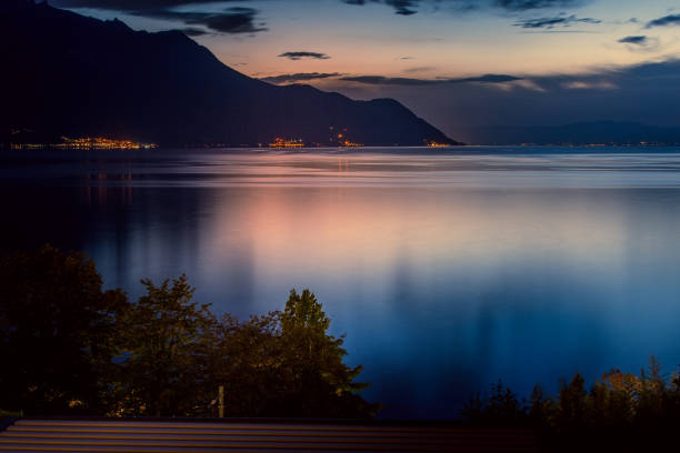 Switzerland, Montreux, night view with lake Switzerland, Montreux, dusk night view of Lake Geneva and Swiss Alps montreux stock pictures, royalty-free photos & images