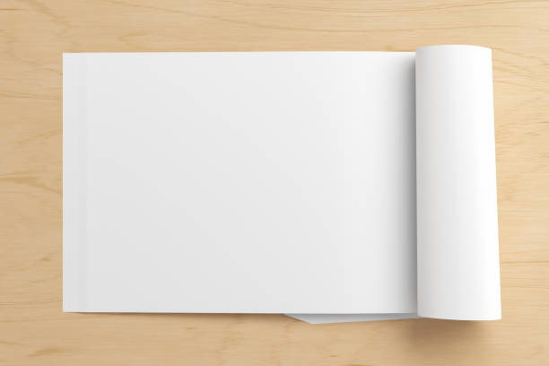 istock Blank magazine page. Workspace with folded magazine mock up on the desk. 1212226584