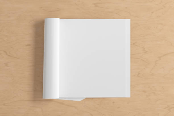 istock Blank magazine page. Workspace with folded magazine mock up on the desk. 1212226631