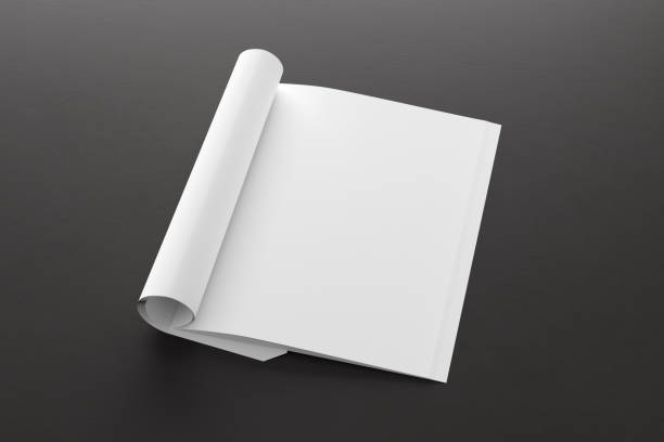 istock Blank magazine page. Workspace with folded magazine mock up on the desk. 1212226666