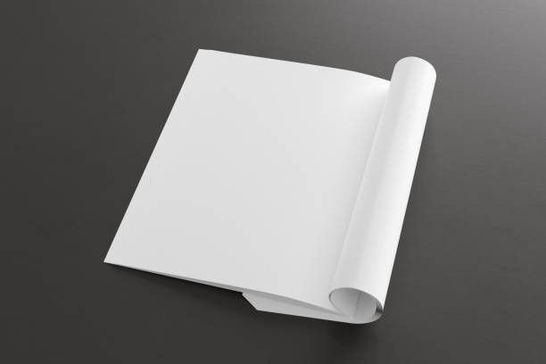 istock Blank magazine page. Workspace with folded magazine mock up on the desk. 1212226704