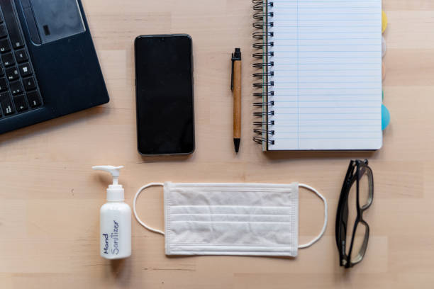 istock remote work kit on wooden office desk with hand sanitizer and face mask, a solution against the spread of corona virus for quarantined employees 1212227044
