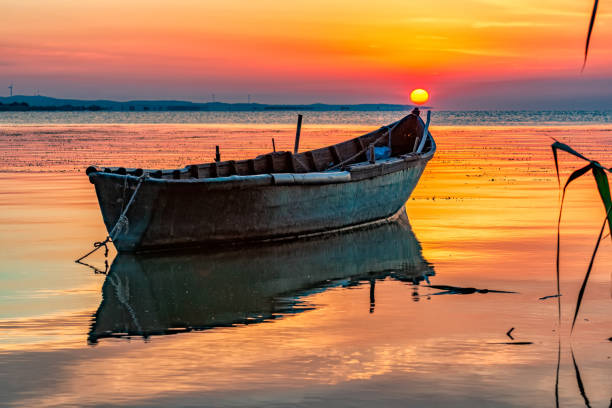 istock Beautiful sunrise with a boat reflected on the Razim lake 1212228273
