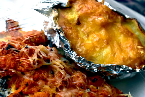 istock Lasagna and fish in a plastic container under a plastic bag 1212229550