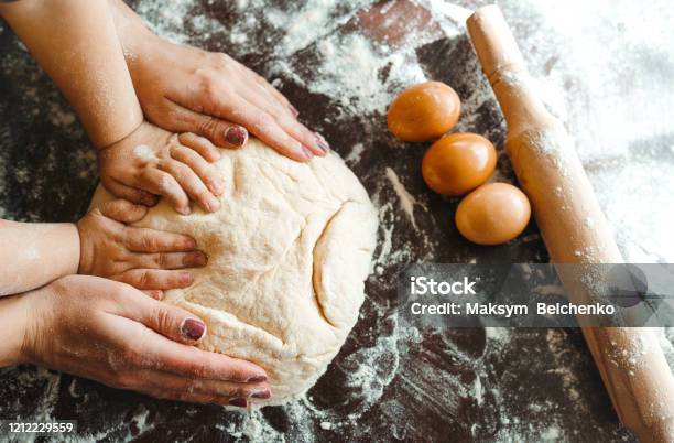 Hands Of Mother And Son Kneading A Dough Together Stock Photo - Download Image Now - Dough, Baking Bread, Flour