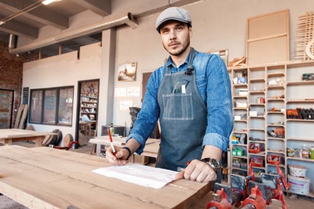 istock Successful handsome businessman with stylish cap work in carpentry 1212230503