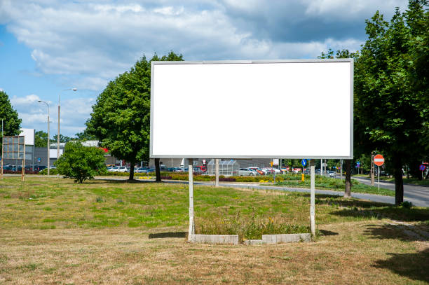 istock Blank white billboard for advertisement in the city. Sumeer day, blue sky with some white clouds. 1212230934