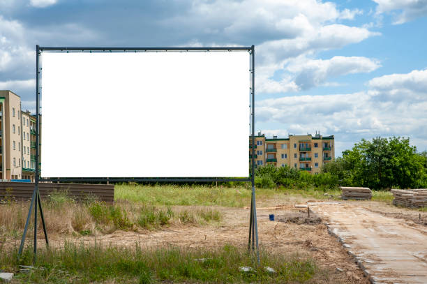 istock Blank white billboard for advertisement in the front of construction site against the residential buildings. 1212230954