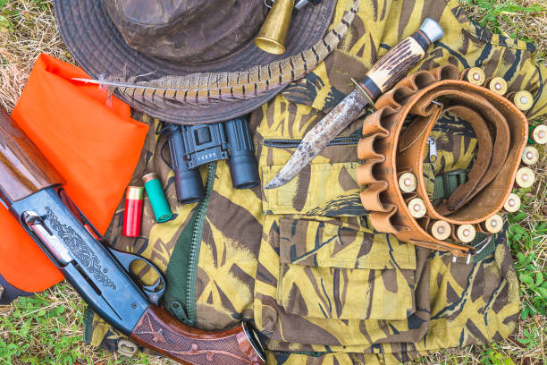 istock Hunting equipment on camouflage 1212232949
