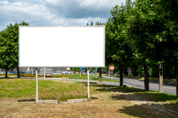 istock Blank white billboard for advertisement in the city. Sumeer day, blue sky with some white clouds. 1212233476