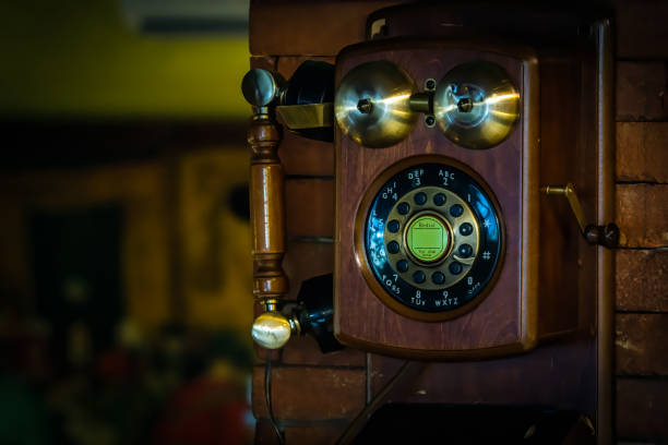 istock Old vintage wall mount telephone on brick wall 1212234232