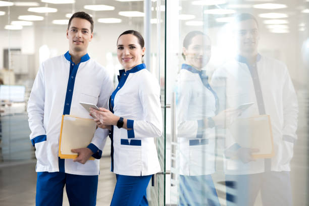 istock Joyful medical workers standing in modern clinic 1212234739