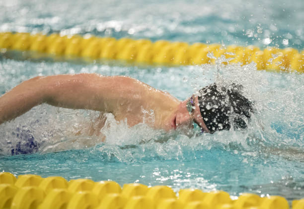istock Young Man Swimming Freestyle 1212235307