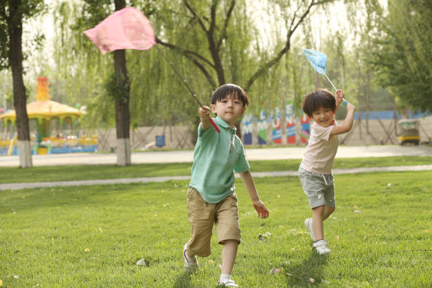 istock Children are playing on the grass 1212235377