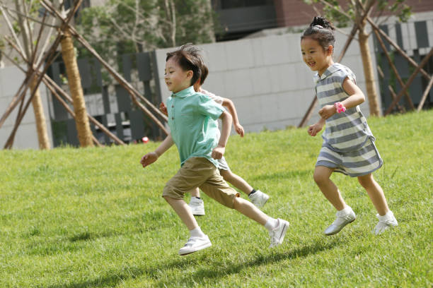 istock Children are playing on the grass 1212235378