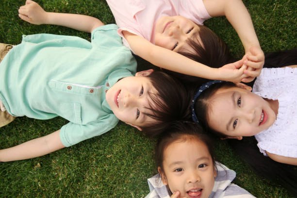 istock Happy children play on the grass 1212235391