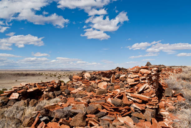 Between 1100AD and 1200AD native people inhabited the plains between the Painted Desert and the San Francisco Peaks of Arizona. In an area so dry it would seem impossible to live, they built pueblos, harvested rainwater, grew crops and raised families. Their way of life was the key to survival in this harsh landscape. These people survived here, farming one of the warmest and driest places on the Colorado Plateau. They developed the skills to farm the land and endure hardship in an area where many would not. Today the remnants of their villages dot the landscape. This Pueblo dwelling is on East Mesa in Wupatki National Monument. The monument, established in 1924 to preserve this rich heritage, is near Flagstaff, Arizona, USA.
