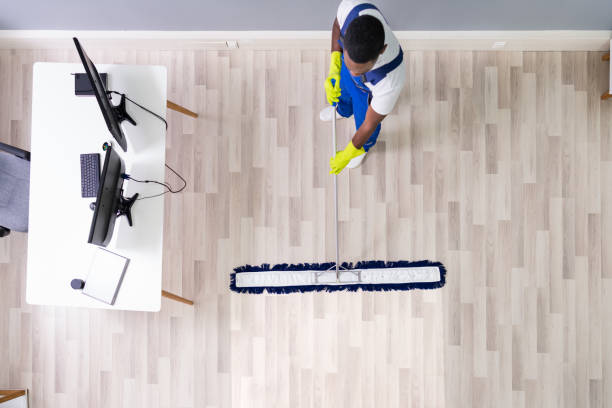 istock Male Janitor Cleaning Floor In Office 1212236058