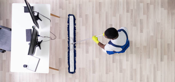 istock Male Janitor Cleaning Floor In Office 1212236059