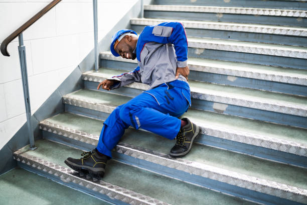 Worker Man Lying On Staircase Worker Man Lying On Staircase After Slip And Fall Accident falling stock pictures, royalty-free photos & images