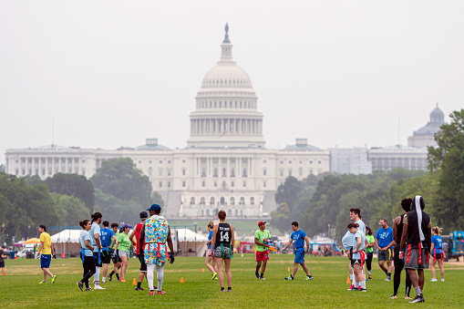 Washington DC, USA - June 9, 2019: People play soccer on the National Mall at Capitol building