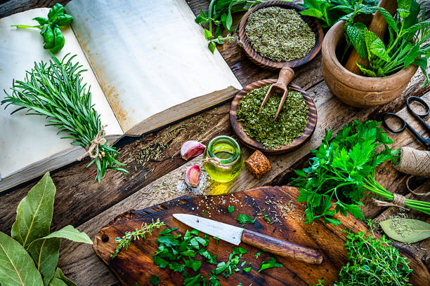 istock Fresh scented organic herbs for cooking shot on rustic kitchen table 1212239335
