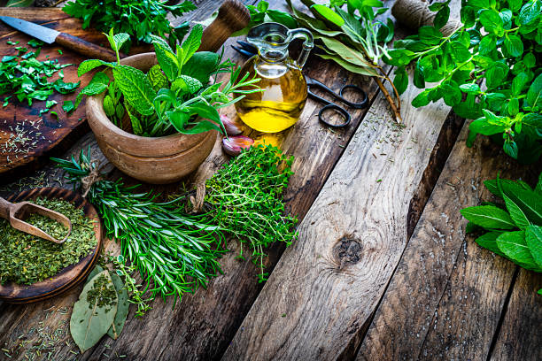 istock Fresh scented organic herbs for cooking shot on rustic kitchen table. Copy space 1212239396
