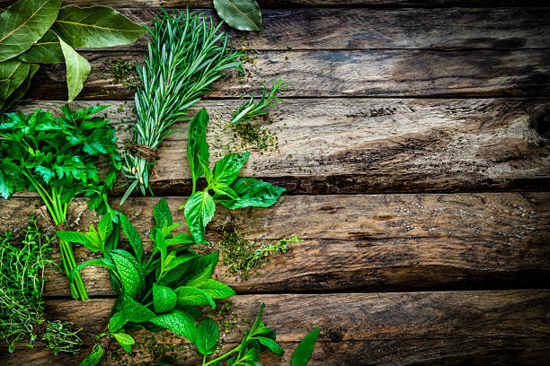 istock Fresh scented organic herbs for cooking shot on rustic kitchen table. Copy space 1212239419