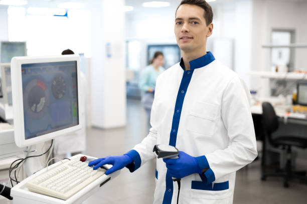 istock Smiling male scientist using lab machine for pathology blood test 1212239473