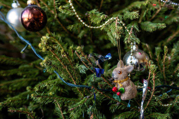 istock Various colorful Christmas decorations hanged spruce branches. 1212239667