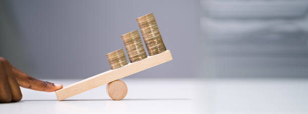 istock Businessperson Balancing Increasing Stacked Coins With Finger 1212241587