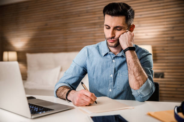 istock Young man working online in evening stock photo 1212245308