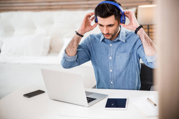 istock Young freelancer using gadgets indoors stock photo 1212245387