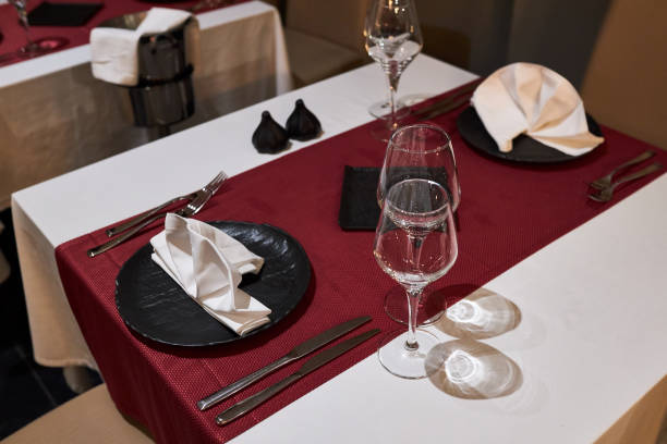 istock Table for two persons in a restaurant decorated with a red tablecloth and black plates 1212251218