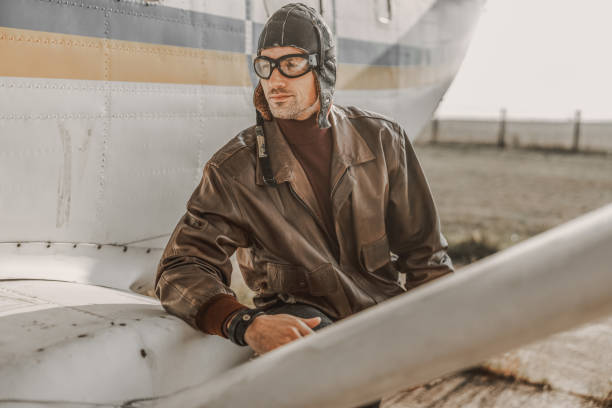 istock Happy young pilot wearing aviator hat outdoors 1212252847