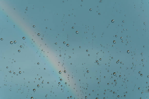 istock A rainbow behind a glass windows with water drops, Point of view 1212252957