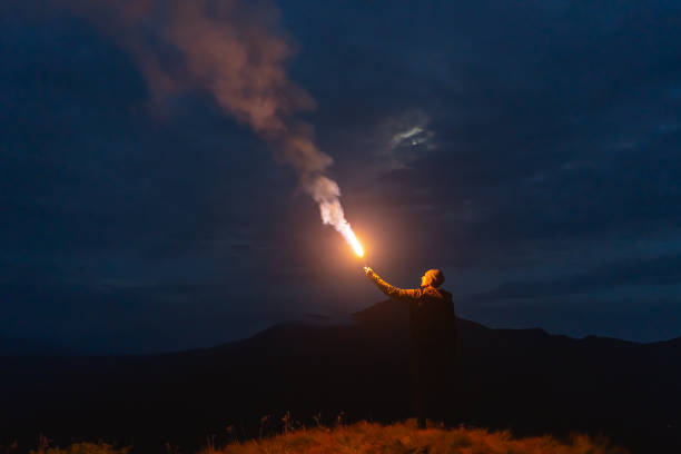 istock The male with a firework stick standing on a mountain 1212259211