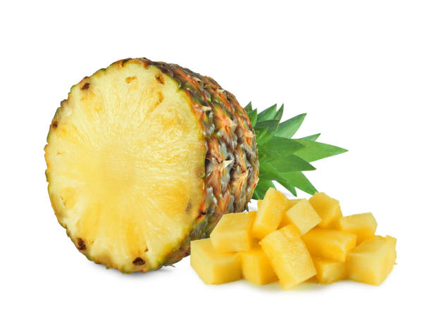 Halved pineapple with chunks isolated stock photo