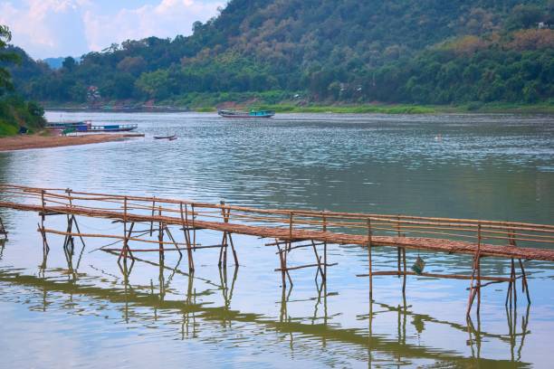 Bamboo bridge over Nam Khan river, in the confluence with Mekong River in Luang Prabang, Laos. Bamboo bridge over Nam Khan river, in the confluence with Mekong River in Luang, Prabang, Laos. bamboo bridge stock pictures, royalty-free photos & images
