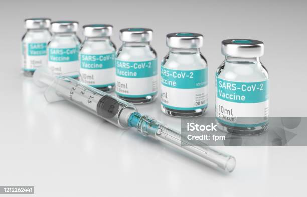 Syringe With Row Of Vials Of Coronavirus Vaccine On Shiny White Stock Photo - Download Image Now