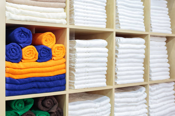 istock Fresh White Hotel Towels Folded and Stacked on a Shelf 1212263293
