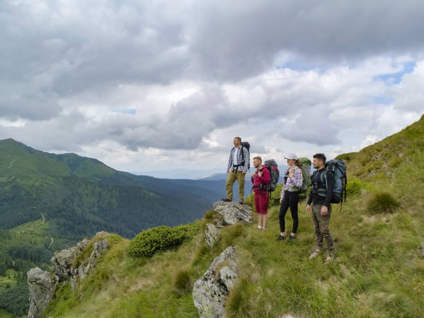istock The four people standing on the picturesque mountain 1212263348