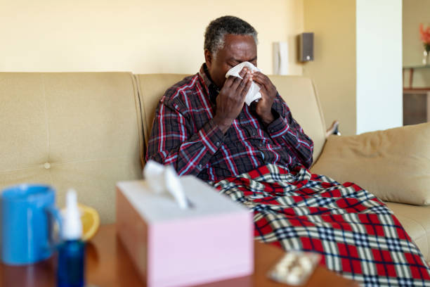 Sick Senior African is Suffering from Flu and Blowing his Nose
