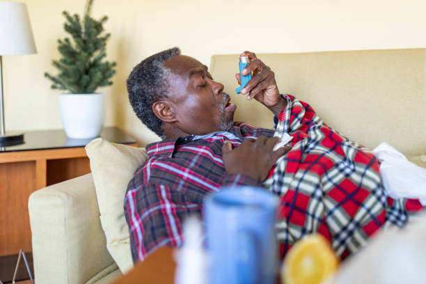 istock Ill Senior Afro-American is Using Asthma Inhaler 1212263620